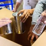 Unrecognizable food bank volunteers organized donated items